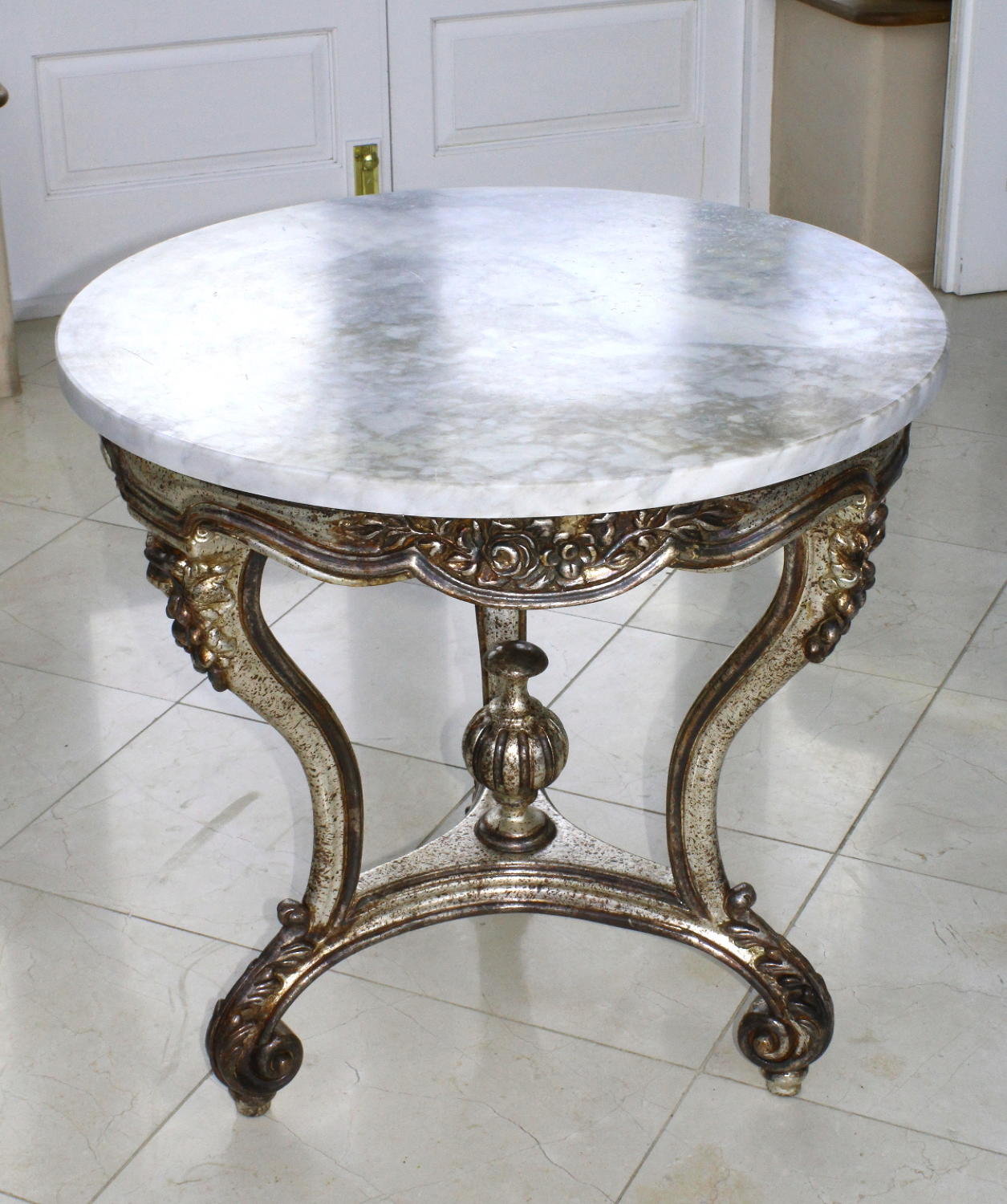 Round table with silverleafed base