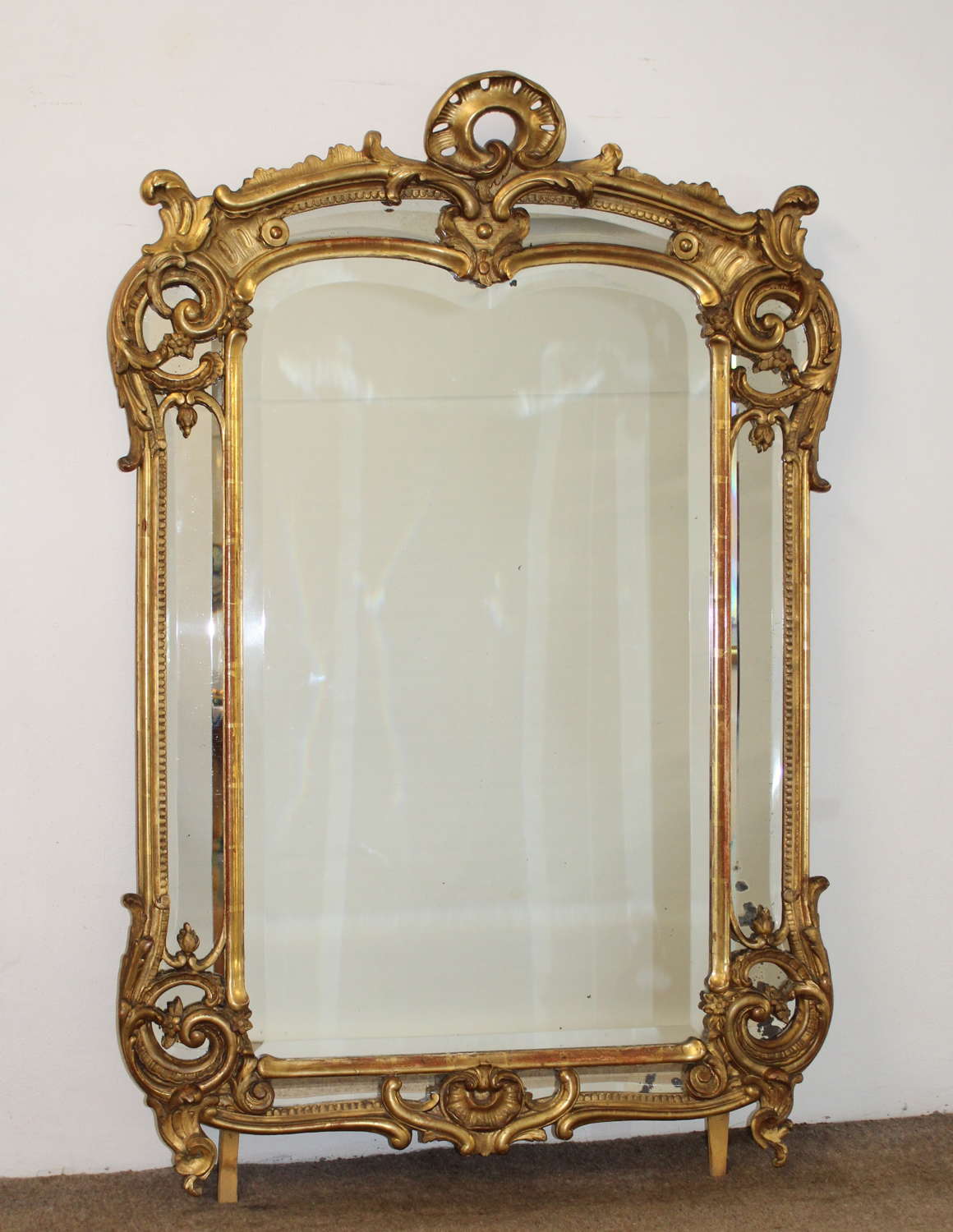 Curvy antique French margin mirror with bevelled glass