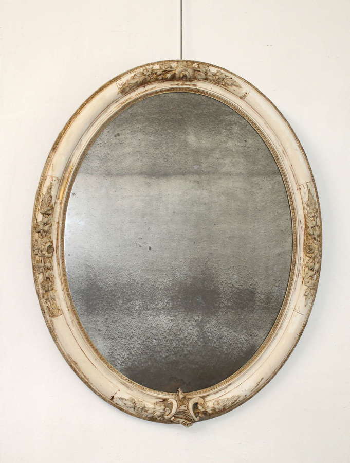 Large antique oval mirror with foxed mercury glass