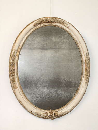 Large antique oval mirror with foxed mercury glass