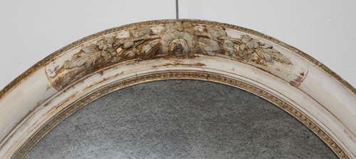 Large antique oval mirror with foxed mercury glass