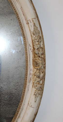 Large antique oval mirror with foxed mercury glass