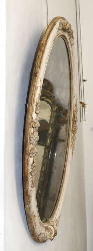 Large antique oval mirror with foxed mercury glass