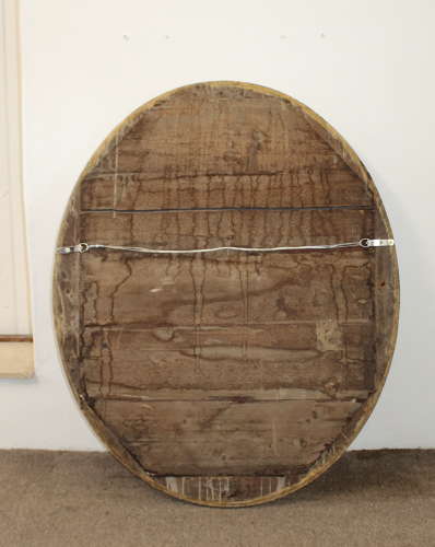 Large antique oval mirror with foxed mercury glass