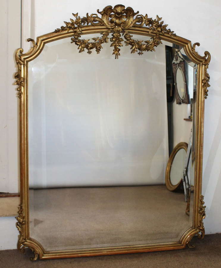 Large elegant antique French mirror with re-entrant corners and swags