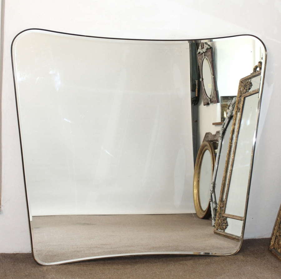 Wide curvy mid-century modern brass framed Italian mirror