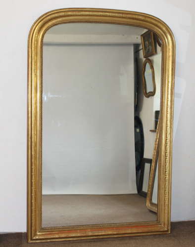 Large antique French curved top mirror with key pattern design