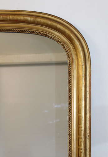 Large antique French curved top mirror with key pattern design