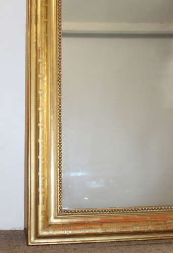 Large antique French curved top mirror with key pattern design