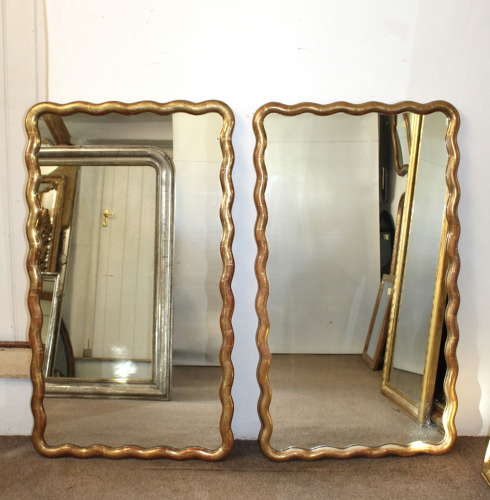 Pair of antique French gilt mirrors with wavy frames