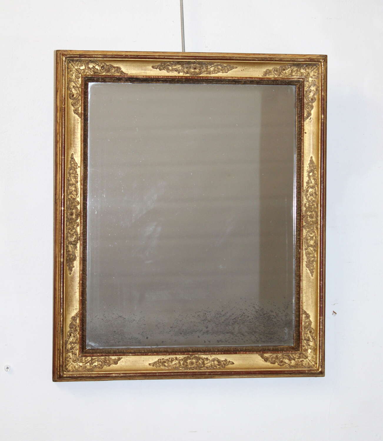Small antique French gilt mirror with decorative frame