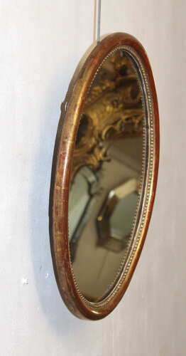 Antique French oval mirror with narrow watergilt frame