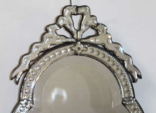 Small antique curvy Venetian mirror with bow