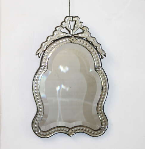 Small antique curvy Venetian mirror with bow