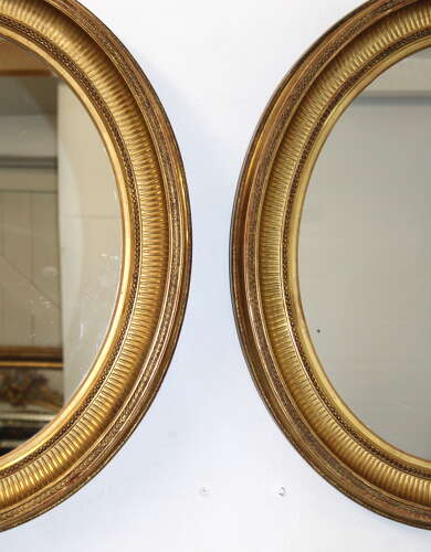 Handsome pair of large antique French oval mirrors
