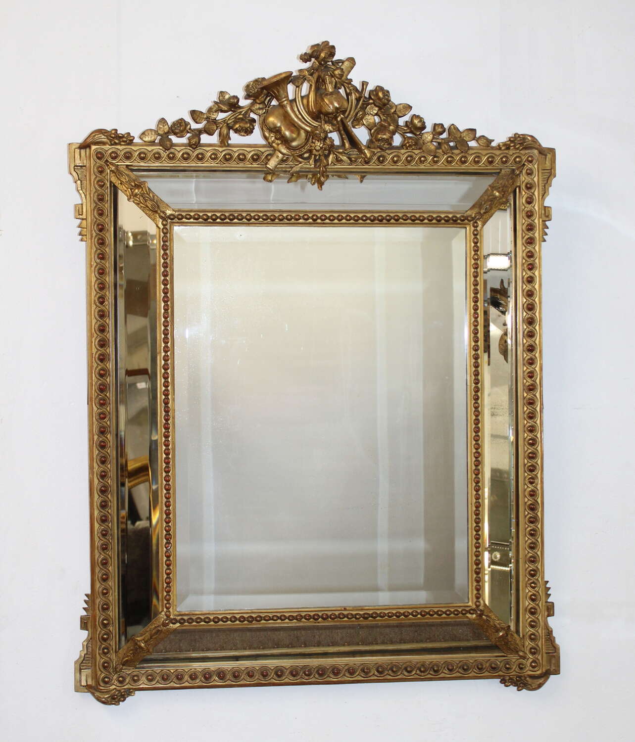 Antique French gilt decorative cushioned mirror
