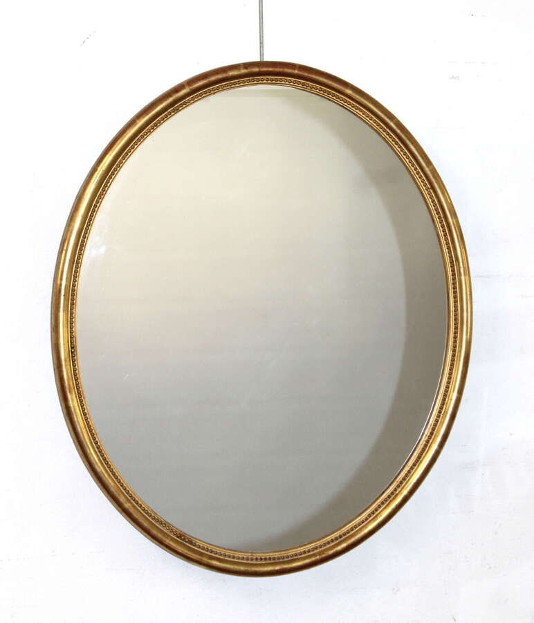 Antique French oval mirror with narrow watergilt frame
